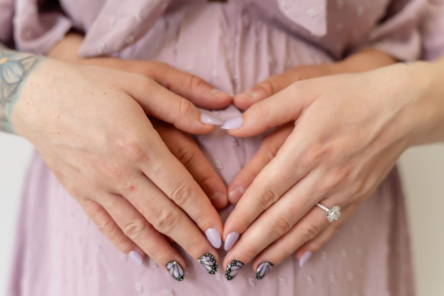 Close up of manicured hands with black and white nail art designs shown from different angles.