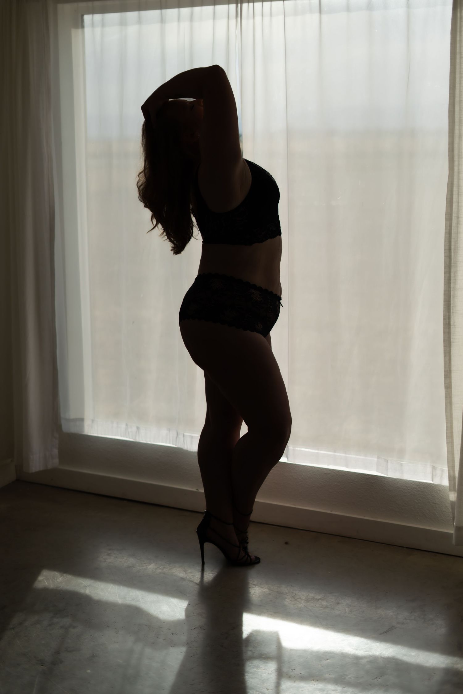 Moody silhouettes against bright window light showing a sequence of graceful poses in black and white.