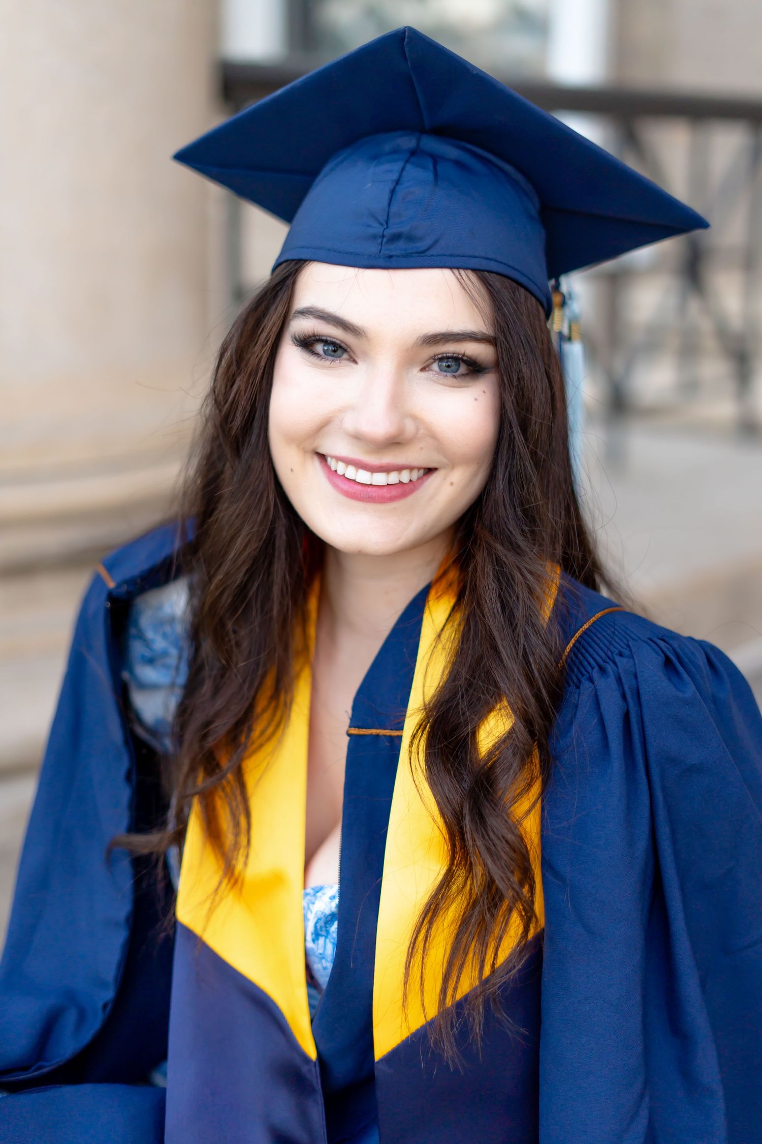 Graduate wearing navy blue cap and gown with gold stole in a series of celebratory poses.