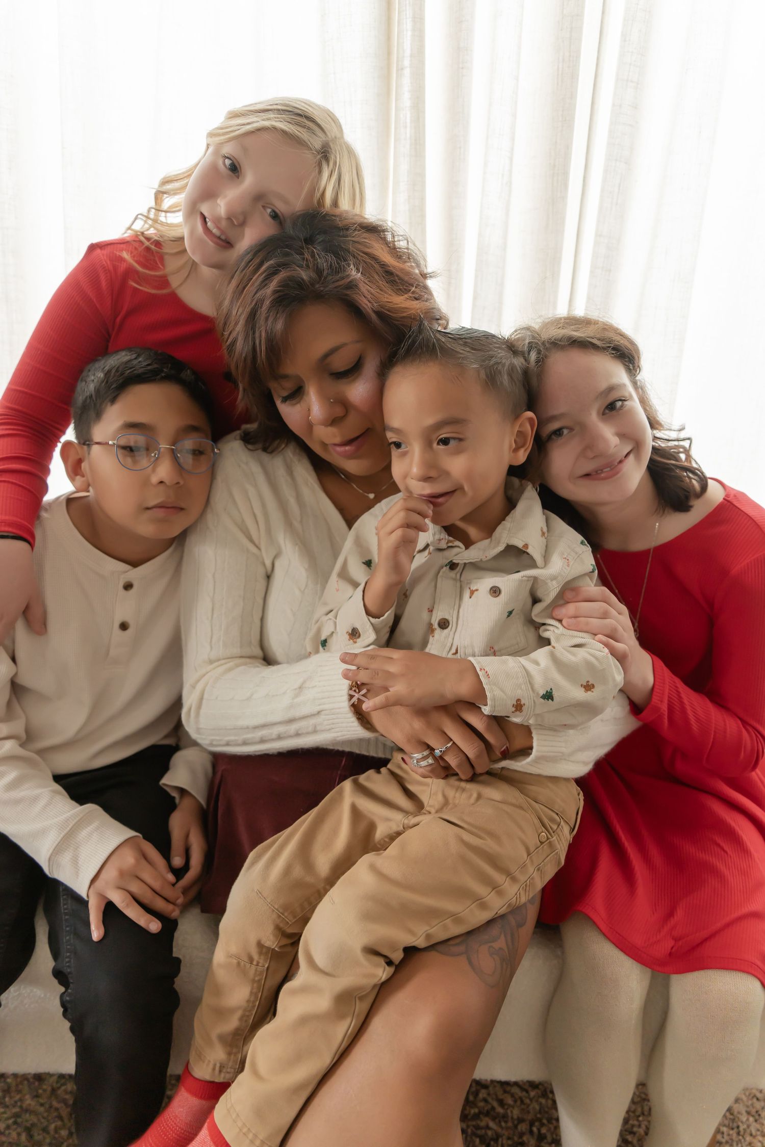 Four children wearing coordinated beige and red outfits sit together in a playful photo collage.