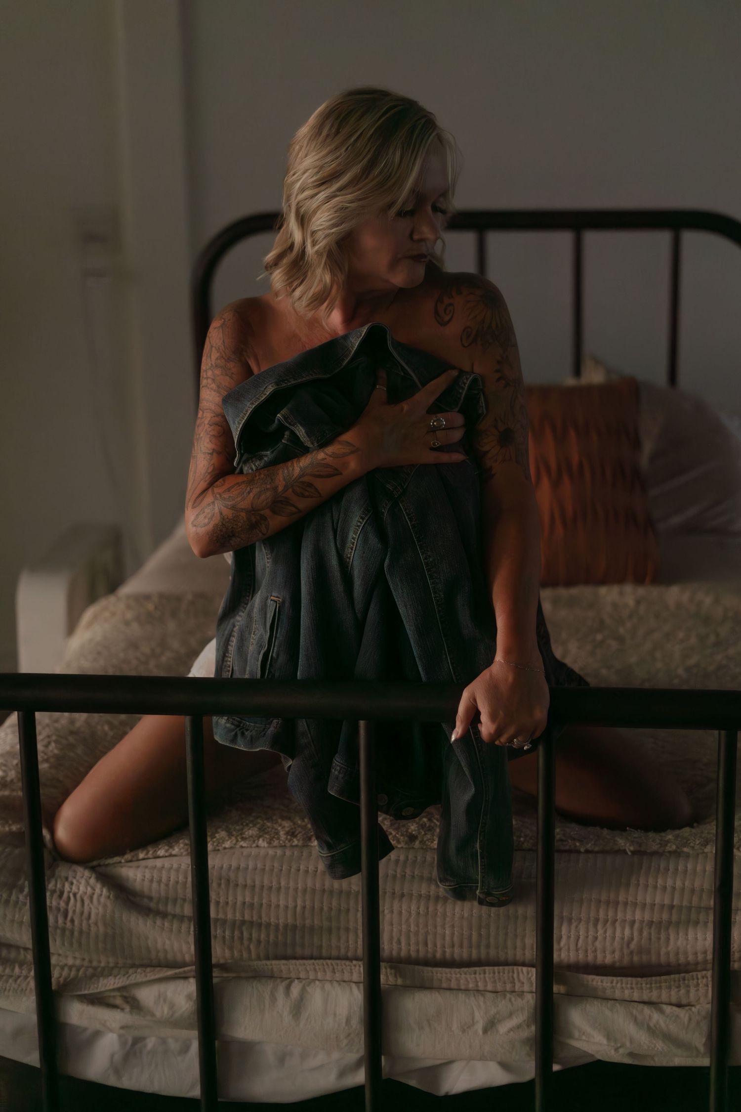 A sequence of intimate black and white photos showing a tender embrace between two figures on a bed.