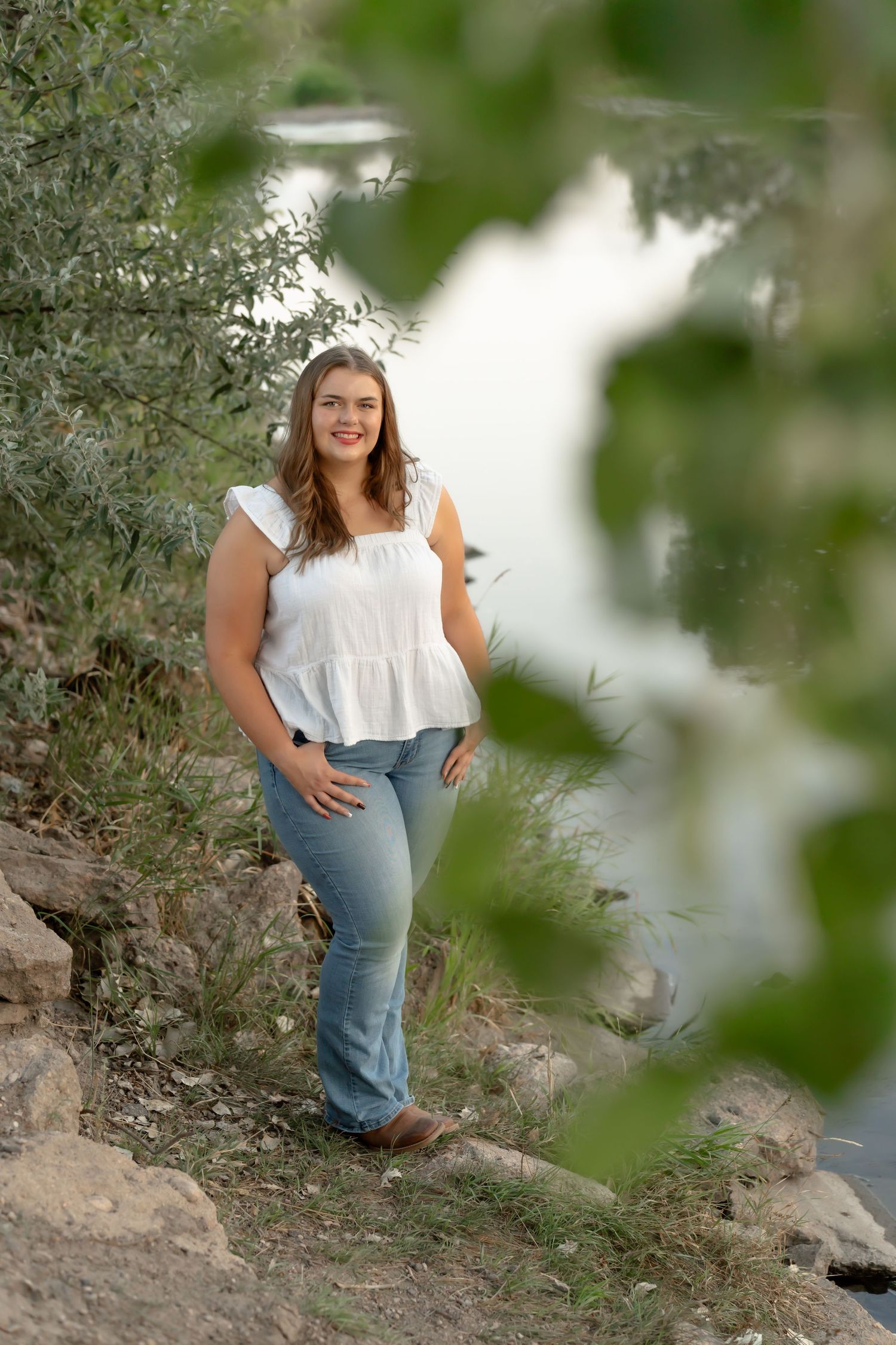 Natural senior photo session near a scenic waterside location with greenery.