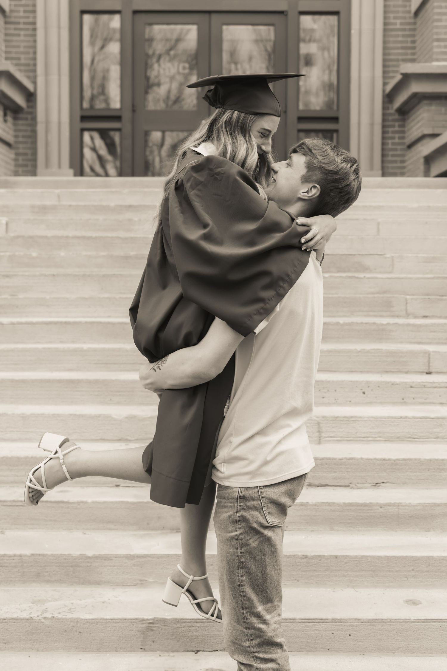 Two children embracing on concrete steps in vintage sepia tones.