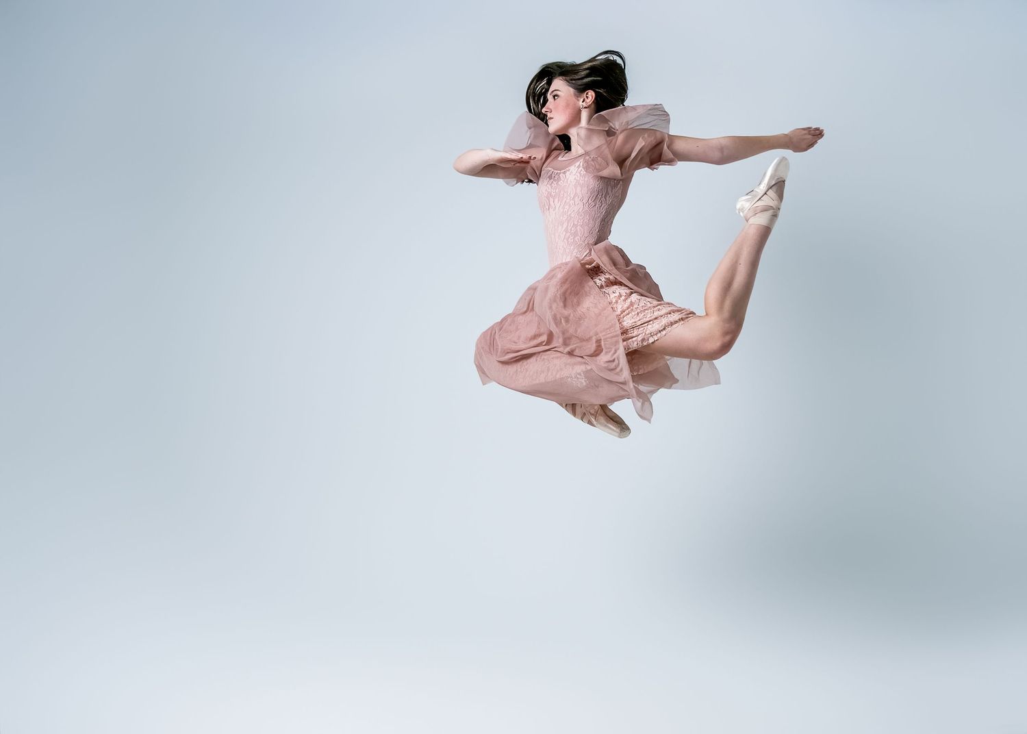 Series of ballet jumps captured in soft lighting showing elegant leaps and extensions.