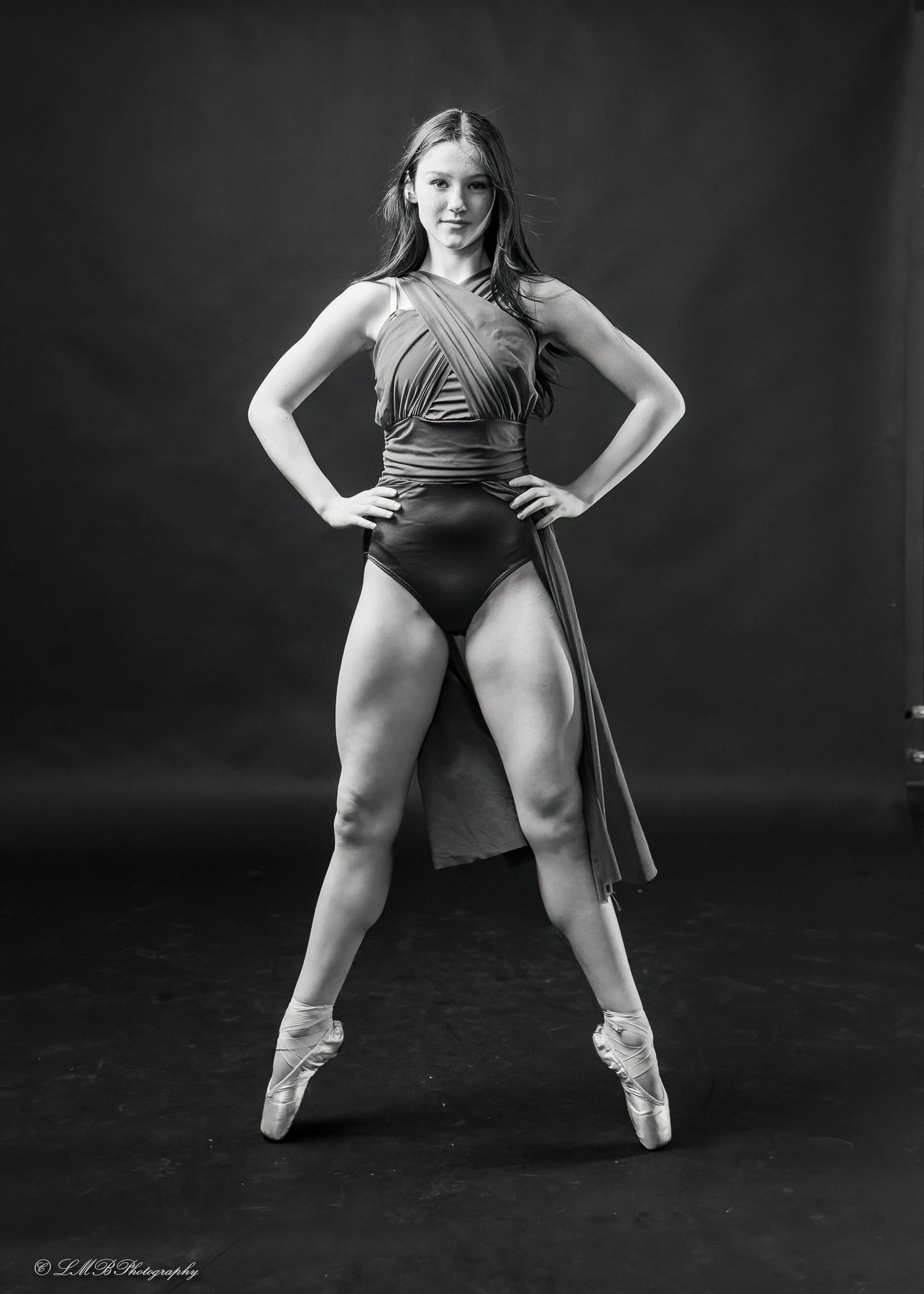 Athletic dancer demonstrates powerful dance poses in black and white photography series.
