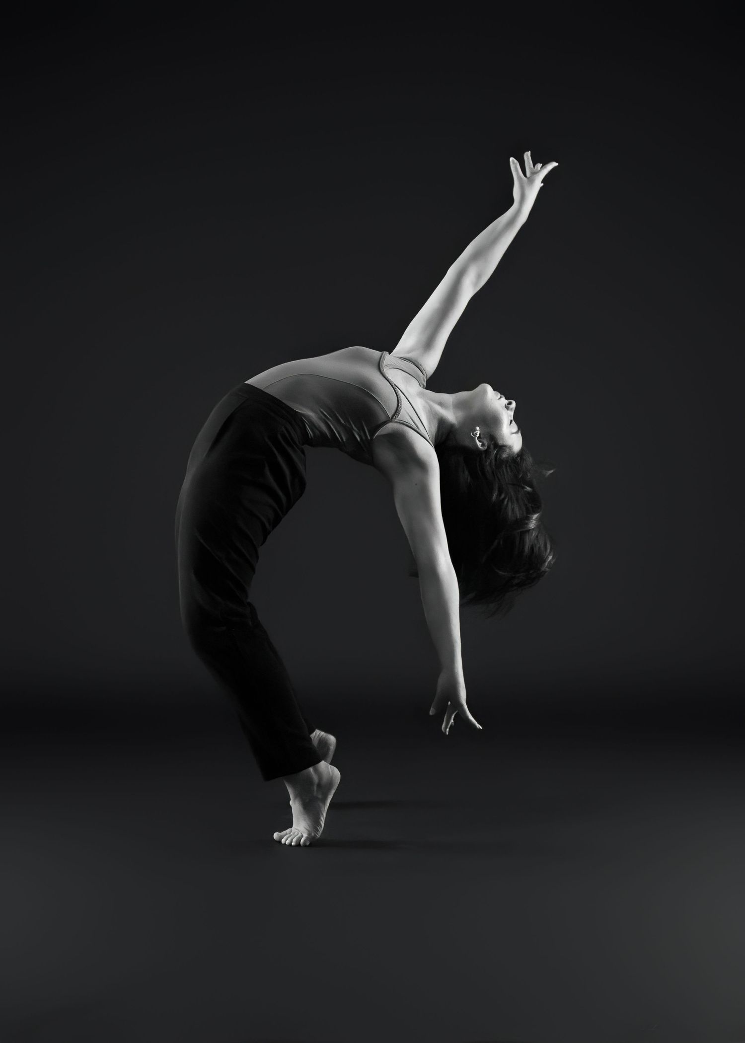 Black and white photo series showing graceful backbend movements in a minimalist setting.