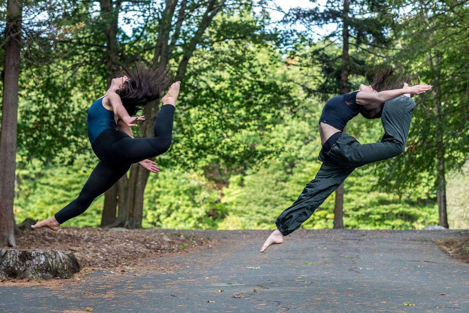 Sequence of parkour-style jumps and flips performed outdoors in a wooded setting.