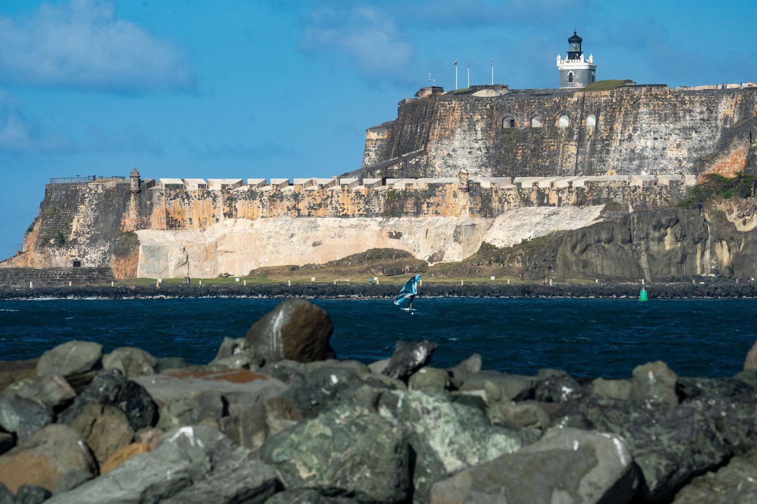 Historic El Morro fortress in Puerto Rico with lighthouse perched on coastal cliffs.