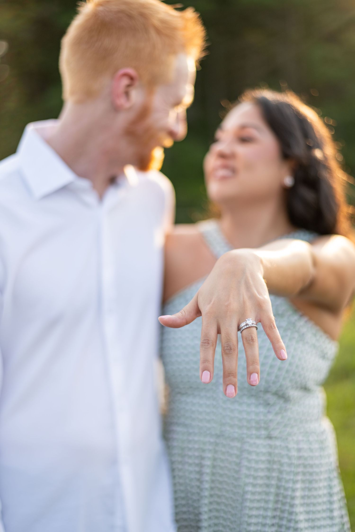 Close-up shots showing engagement ring display and romantic poses against sunset.