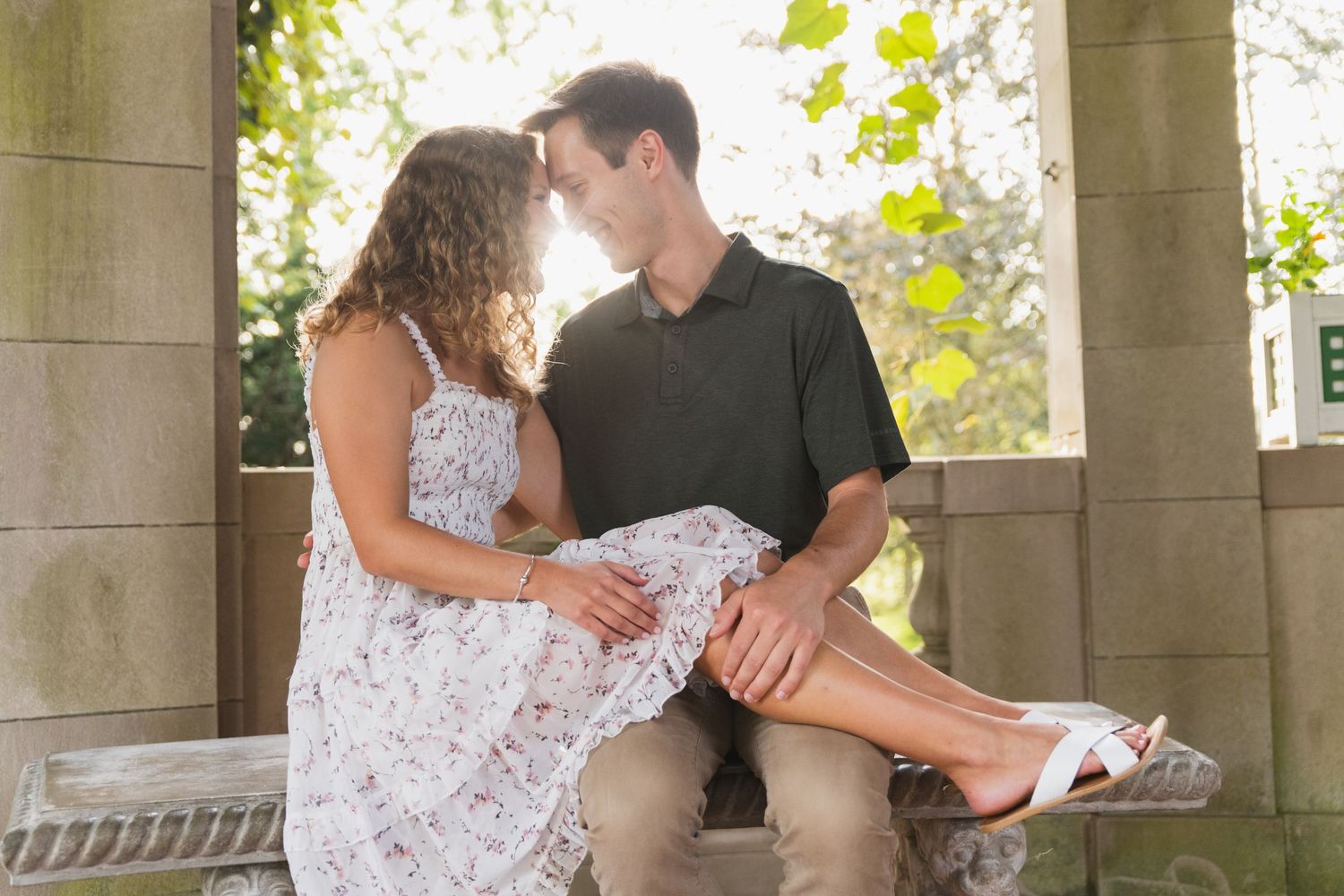 A couple dances together under elegant stone pillars in a romantic outdoor setting during a special celebration.