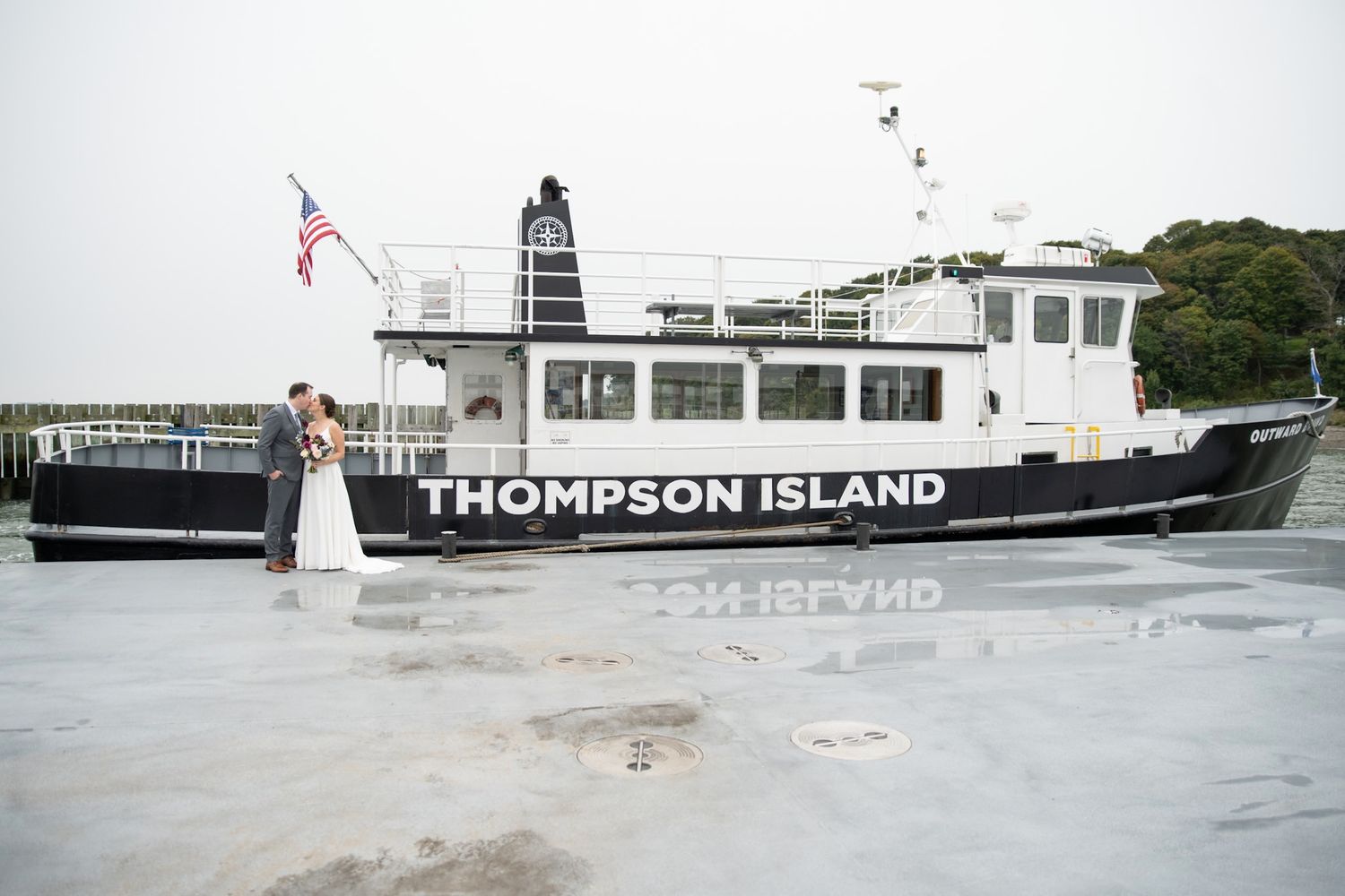 A couple poses for wedding photos on the Thompson Island ferry boat.