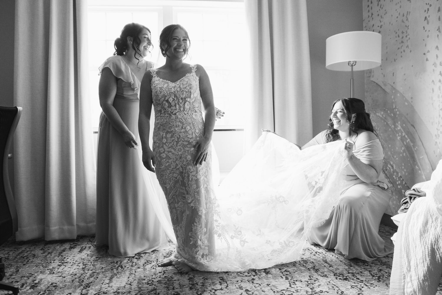 Black and white images of bridal preparation moments by window light.