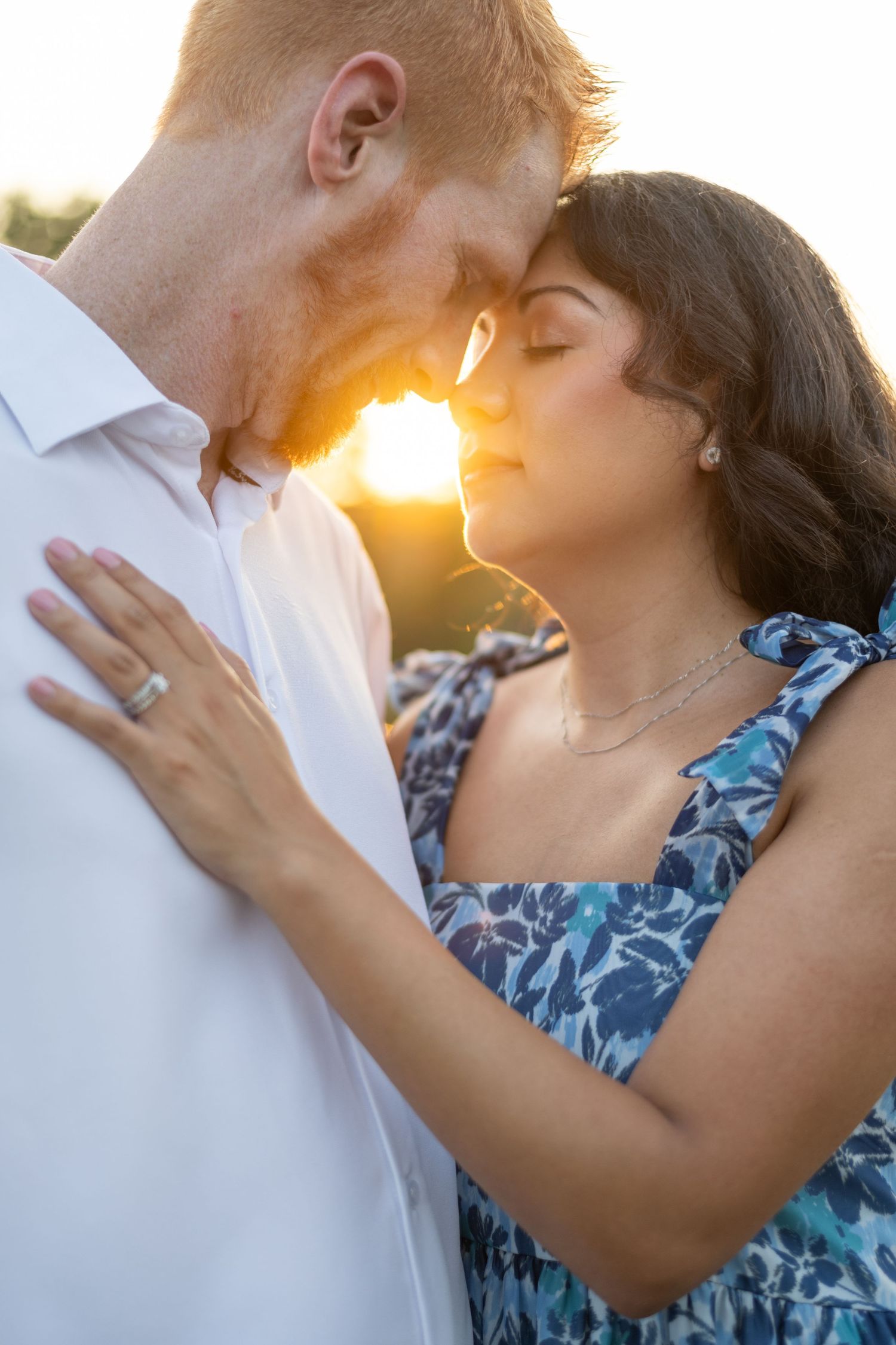A romantic sunset photoshoot with a couple in summer attire against golden light.