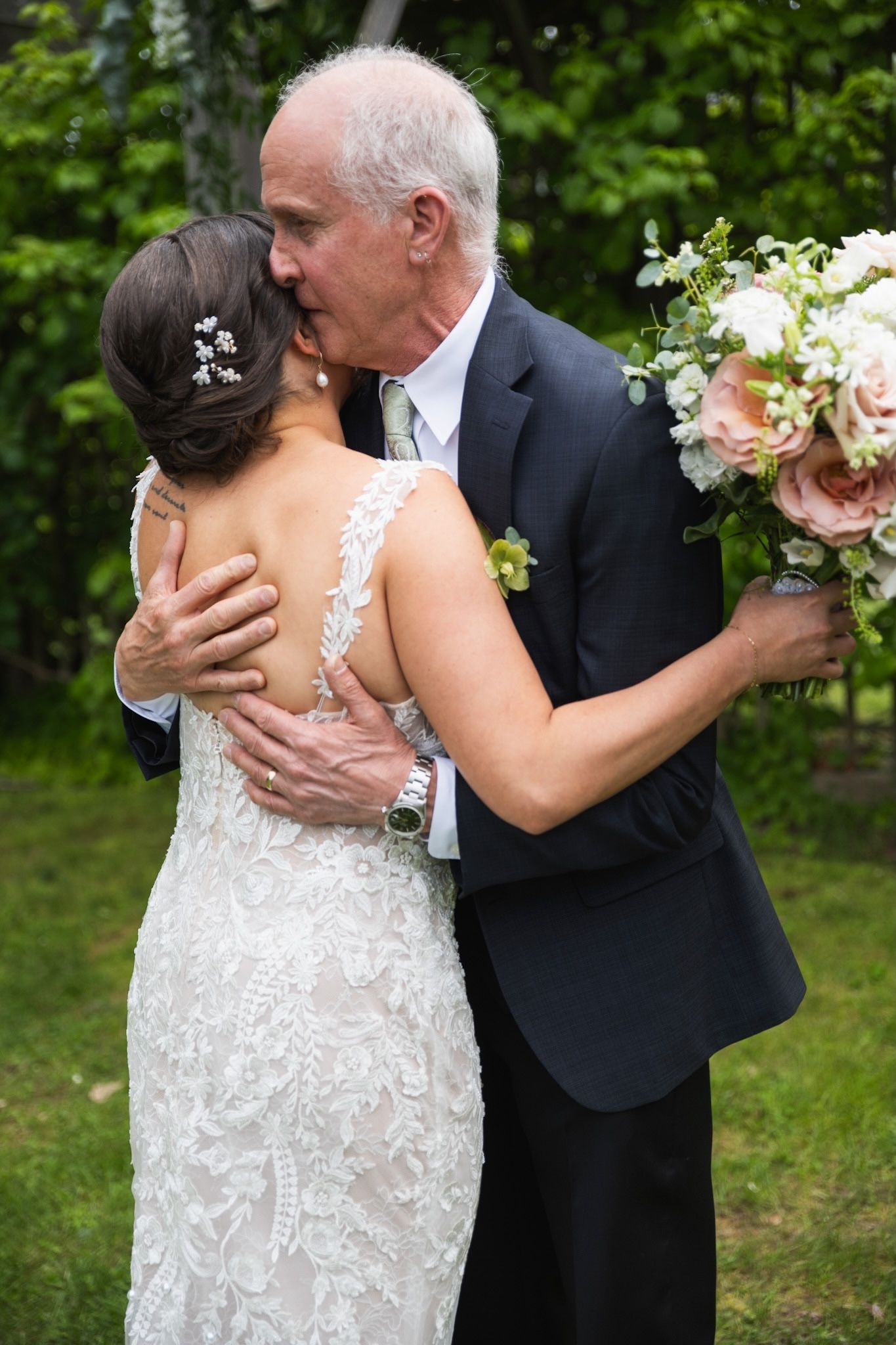 Emotional outdoor wedding photos captured in a lush green garden setting.