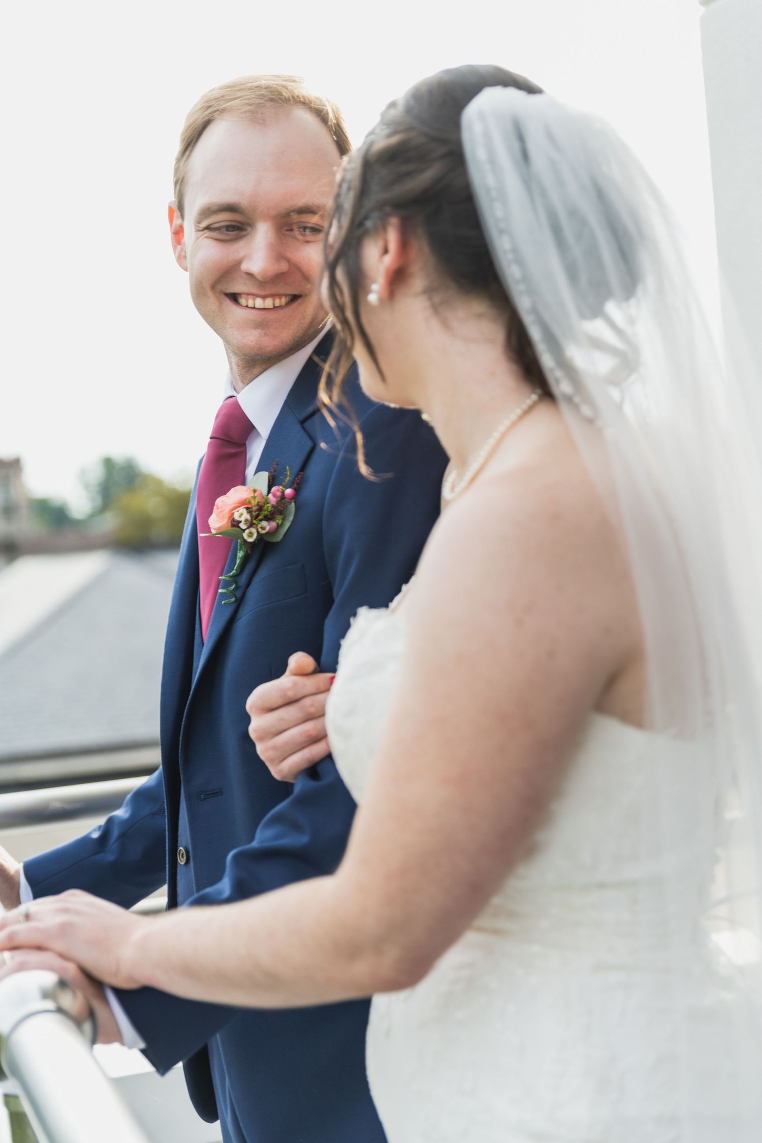 Candid moments between newlyweds sharing laughter during their first look wedding photos.