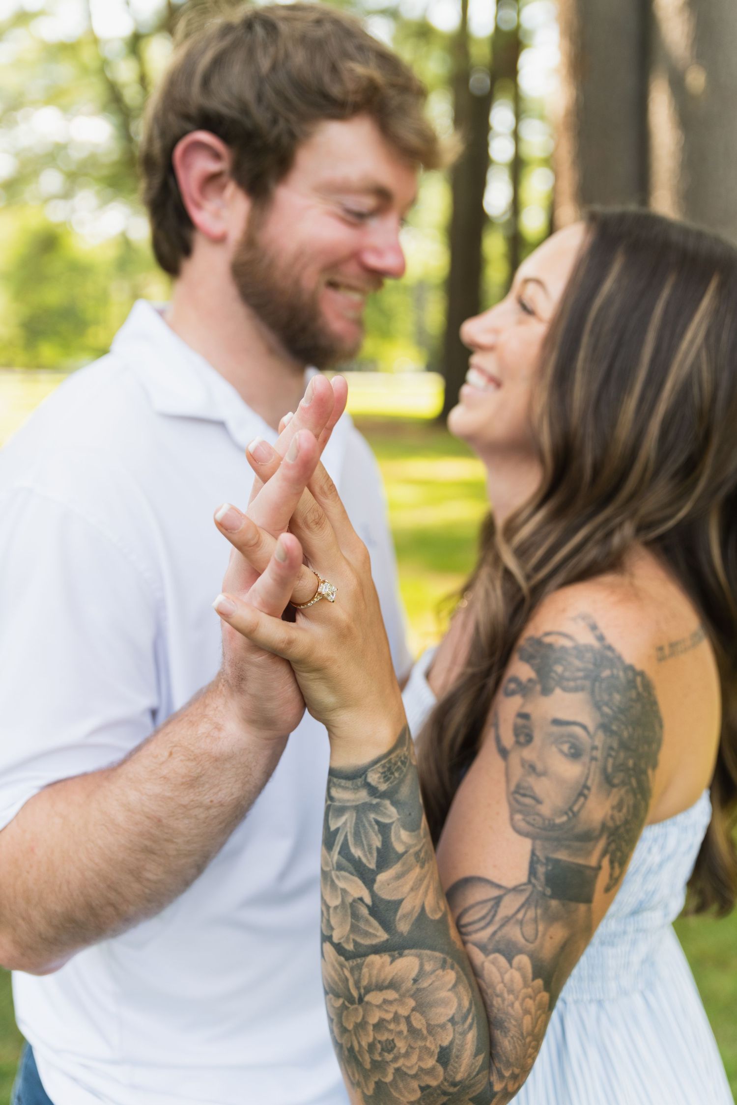 Artistic engagement photo series showing details of hands and tattoos in a natural outdoor setting.