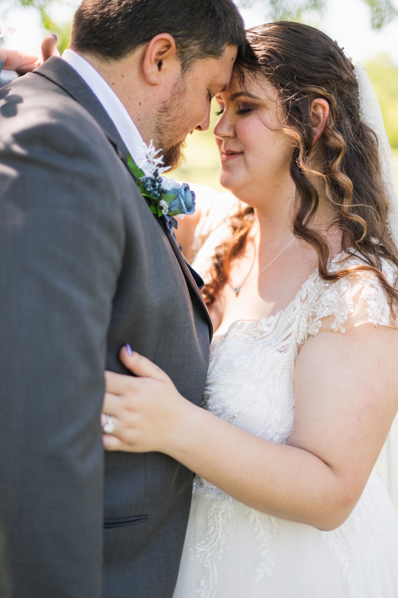 Close-up shots of tender moments between newlyweds during their outdoor photo session.