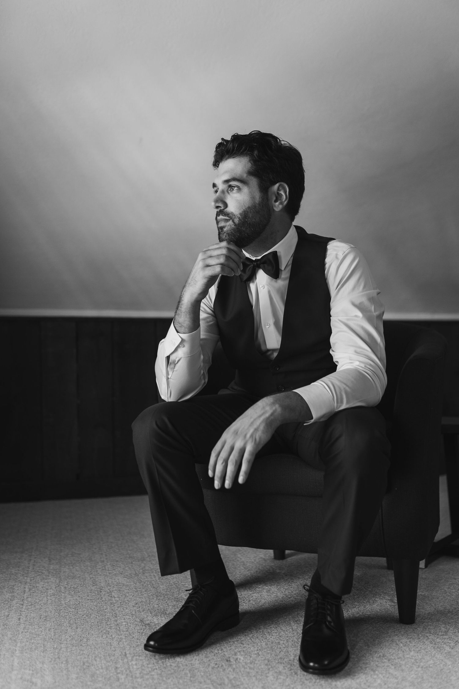 Artistic black and white portrait series showing a contemplative figure seated in various thoughtful poses.