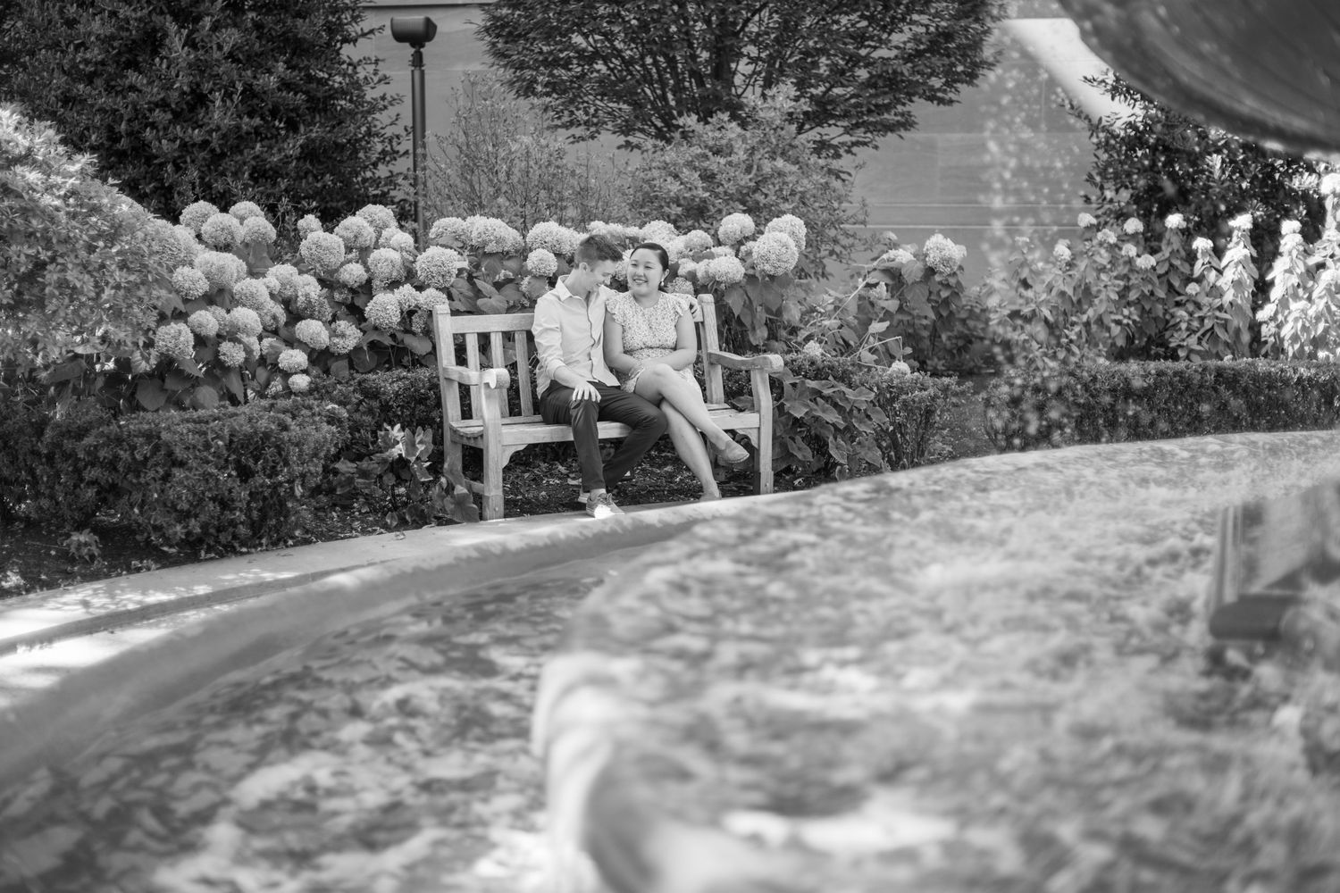 A romantic outdoor photo series with natural garden elements and wooden fence backgrounds.
