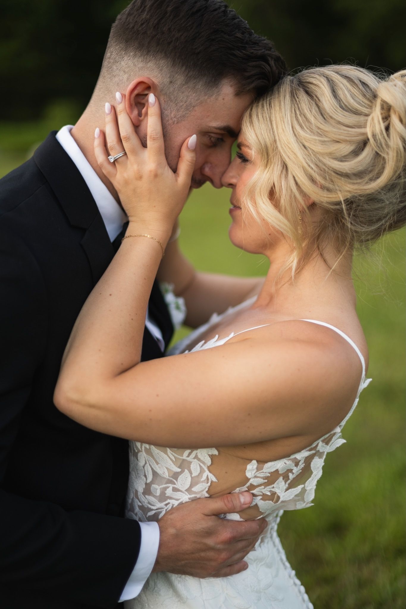 Romantic wedding couple portraits with soft natural lighting against a green outdoor backdrop.