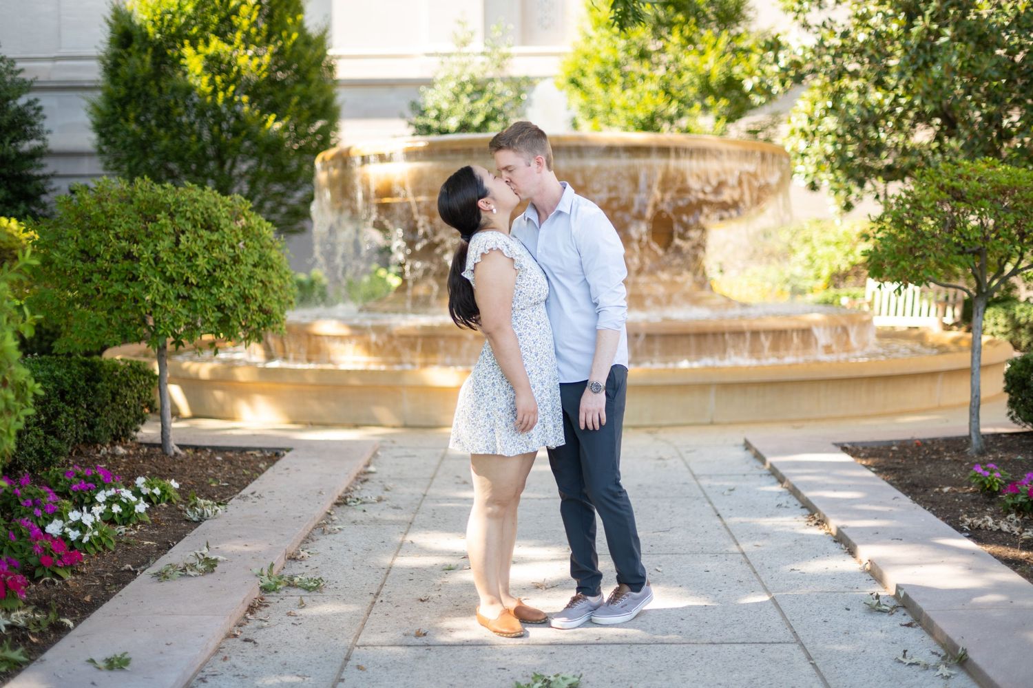 A romantic garden photo series showing tender moments between a couple on stone steps.