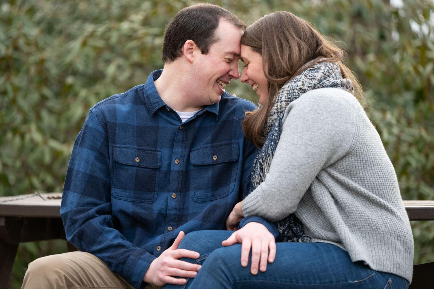 Intimate moments captured between couple wearing coordinating blue and gray outfits.