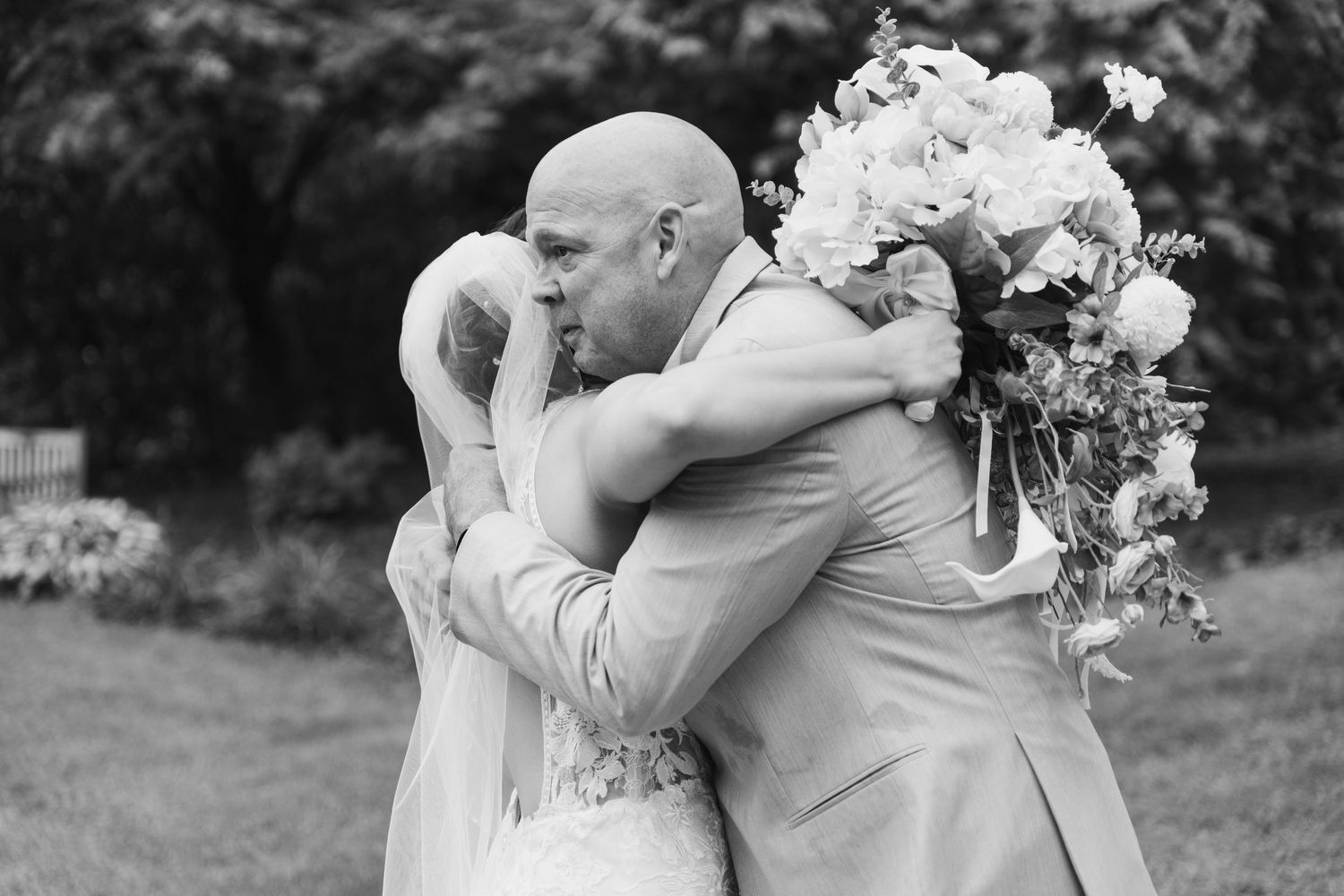 Black and white romantic wedding portraits in garden setting.