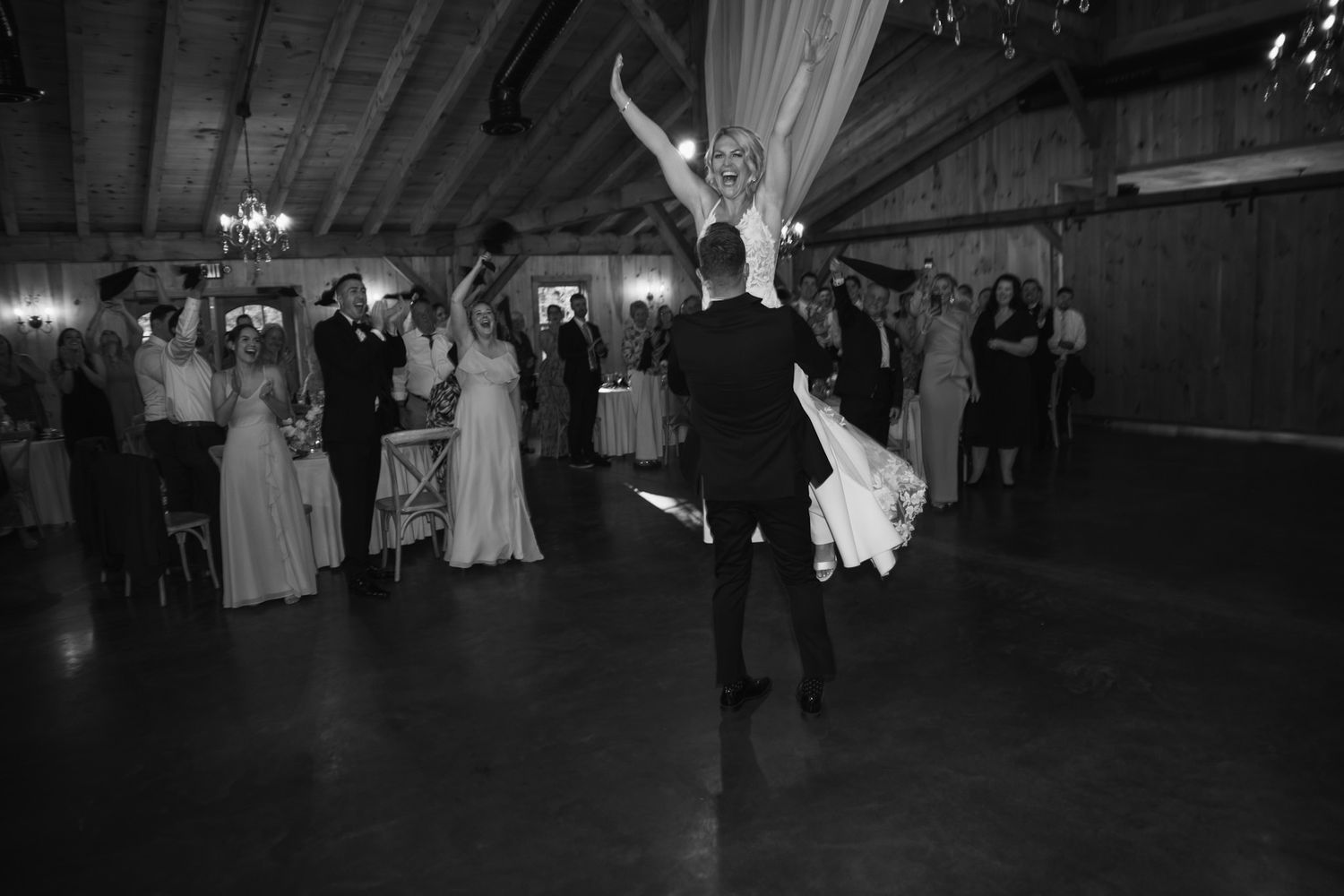 Dance floor moment captured in black and white at wedding reception.