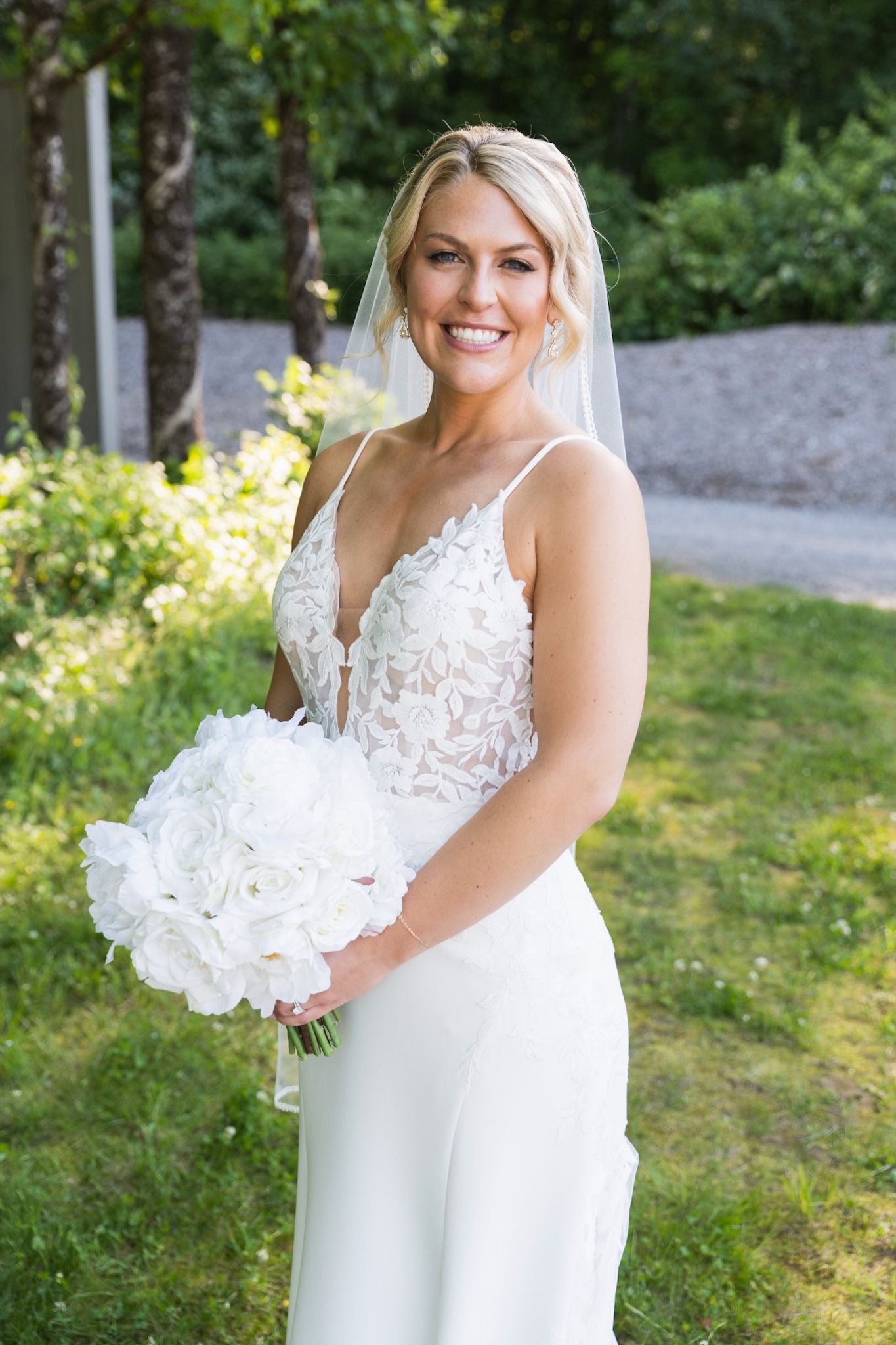 Beautiful bridal portraits showcase lace wedding dress details in garden setting.