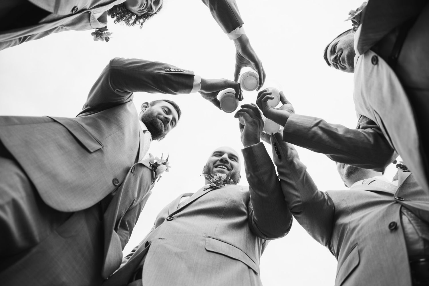 Wedding photographer captures romantic candid moments outdoors in natural lighting.