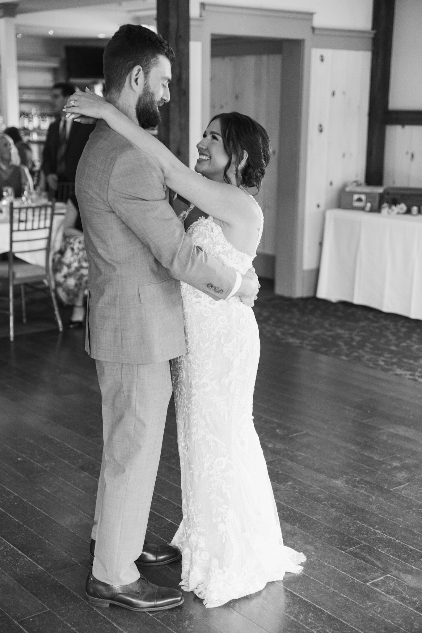 Dancing couple sharing a tender moment on a wooden dance floor.