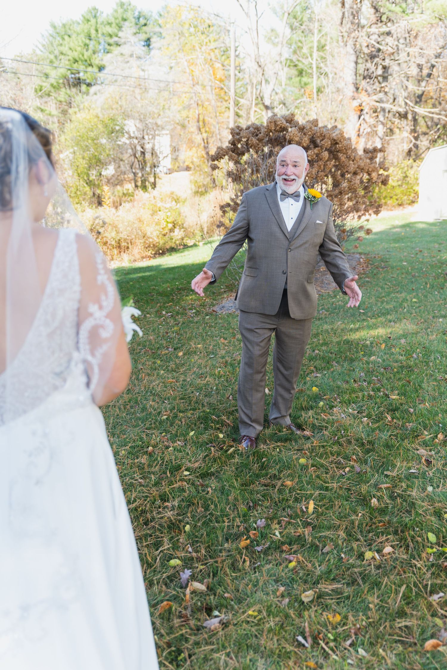 Emotional first look between bride and groom in autumn garden setting.