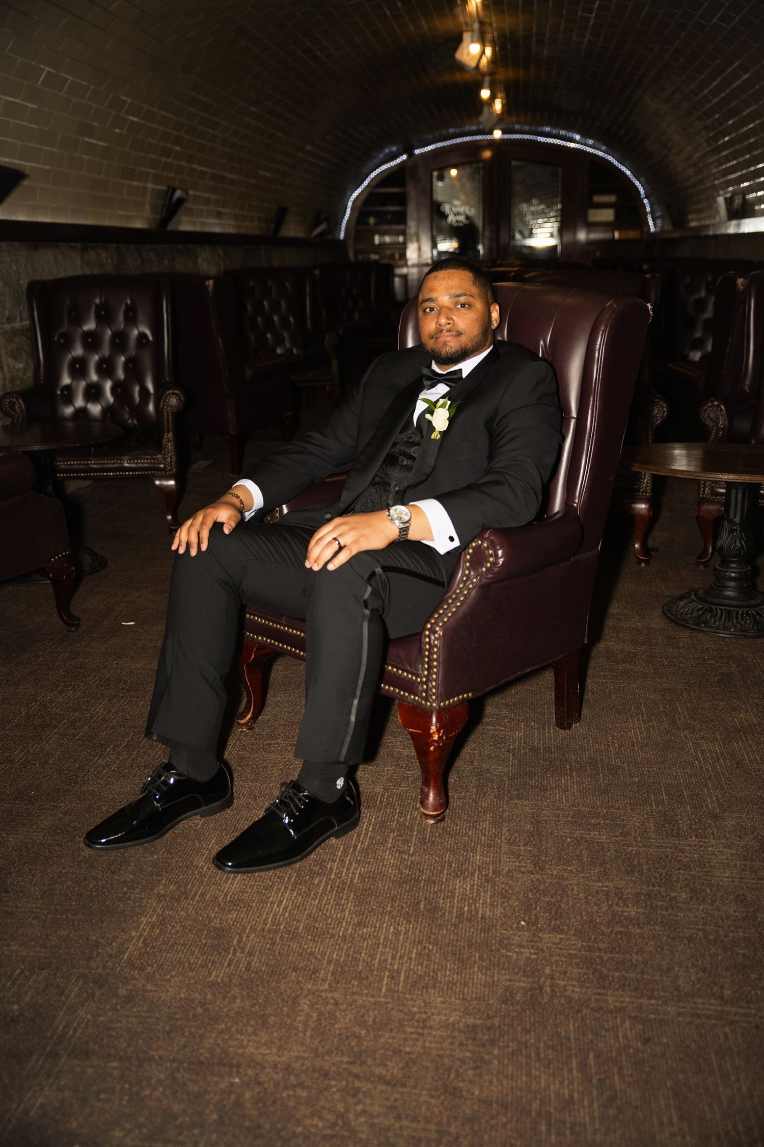 Stylish groom lounging in leather chair shown in creative multi-angle photography sequence.