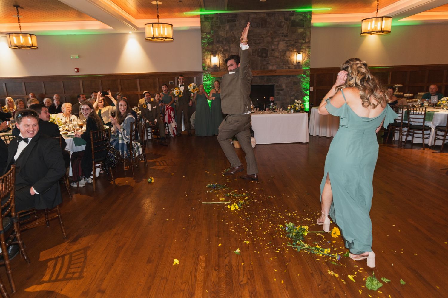 Wedding reception dance floor with warm lighting and guests enjoying the celebration.
