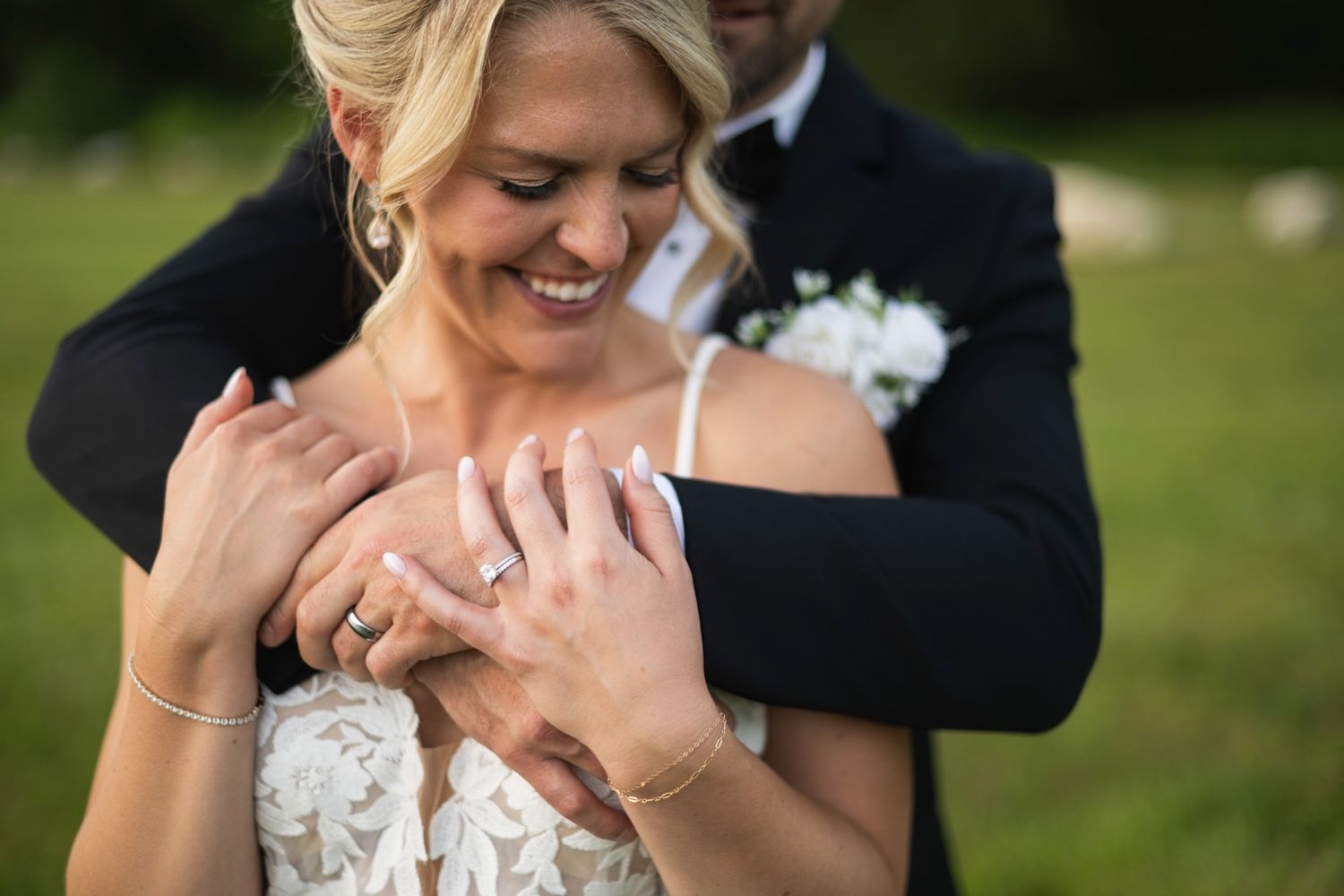 Romantic outdoor wedding portraits captured in natural lighting with white floral decor.