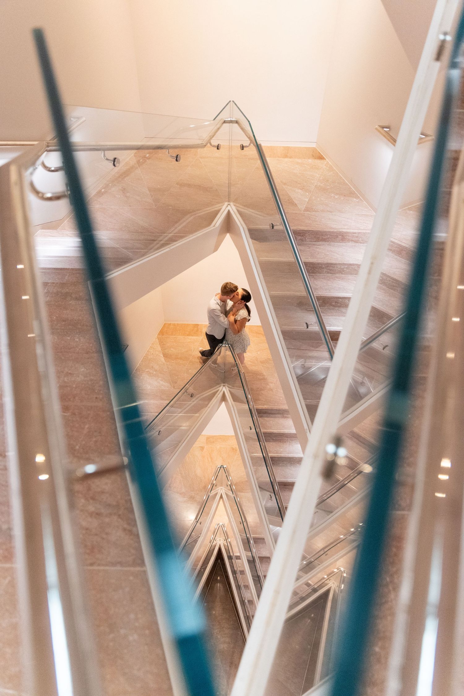 Modern geometric ceiling installation with diagonal white beams and lighting creating an architectural pattern.