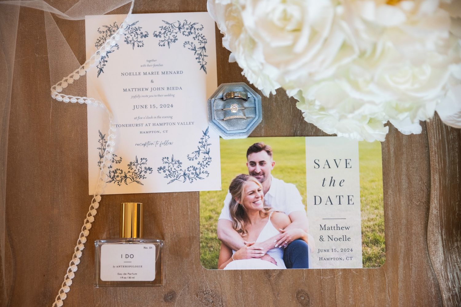 Wedding stationery and save the date cards arranged with decorative floral elements.