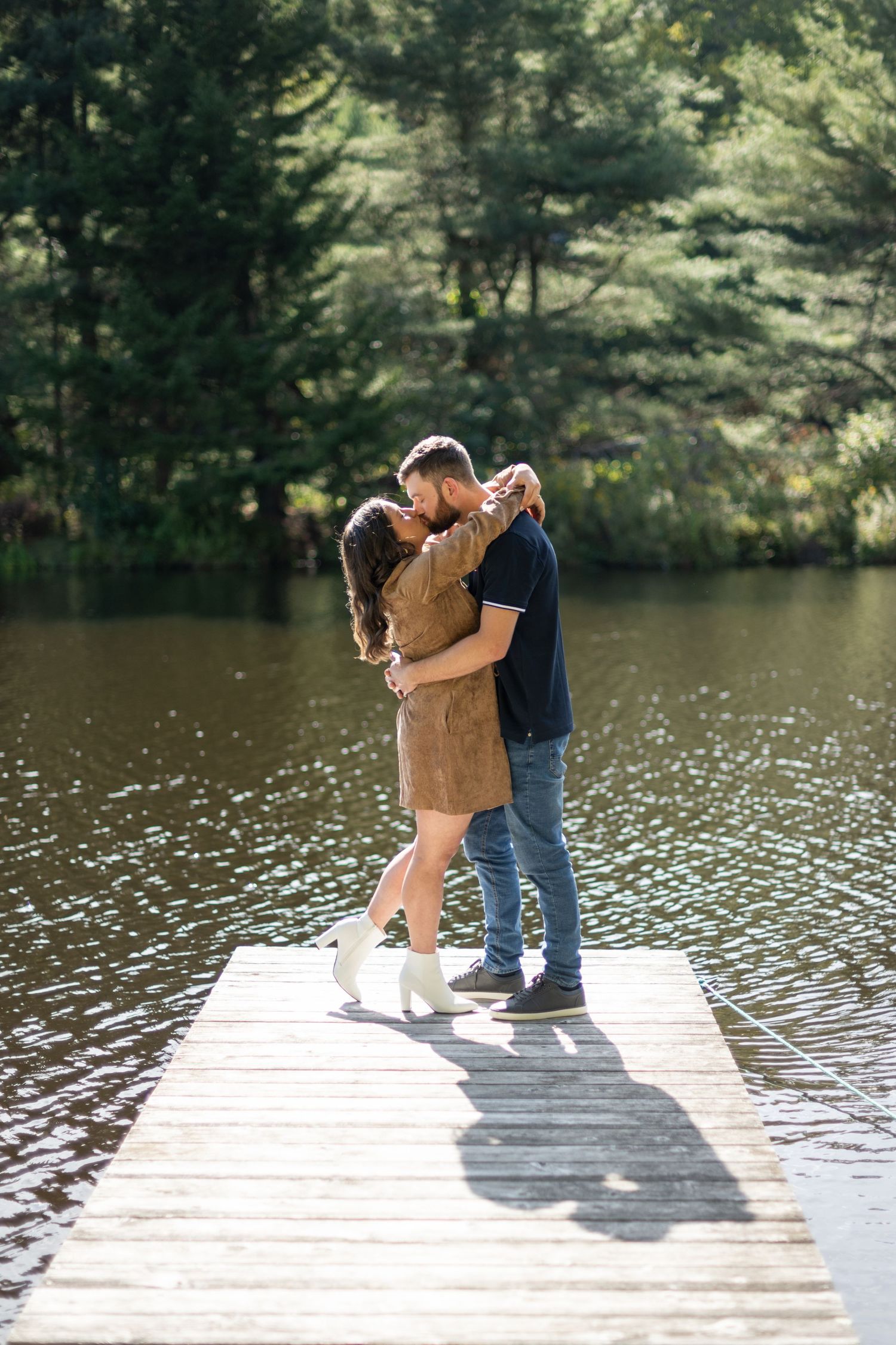 Series of romantic moments captured on a lakeside dock during a summer photo session.