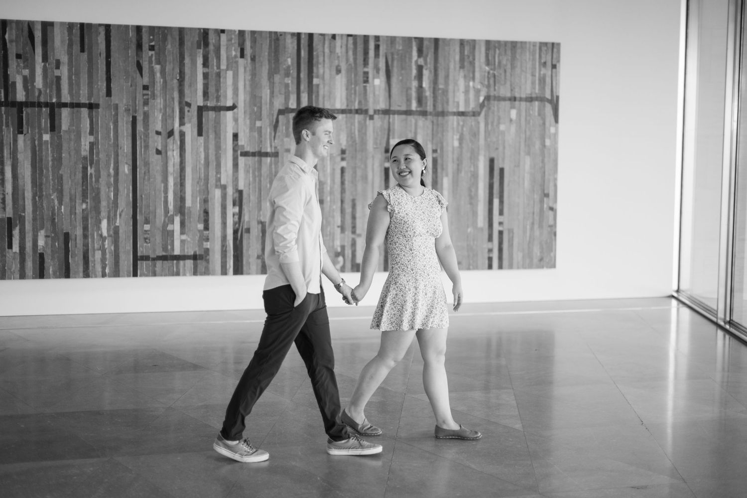 A black and white photo series capturing intimate moments between a couple in an industrial space.