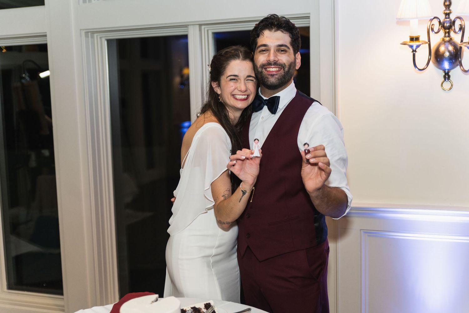 Wedding celebration moments captured in an elegant reception venue with white decor.