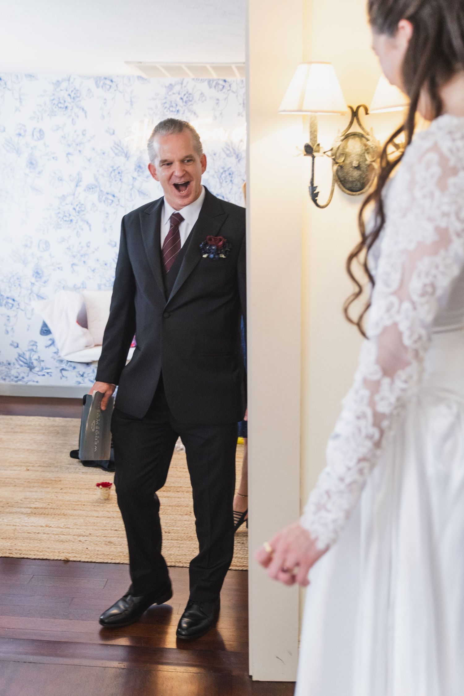 Series of emotional reactions during a first look moment between a person in a suit and someone in a wedding dress.