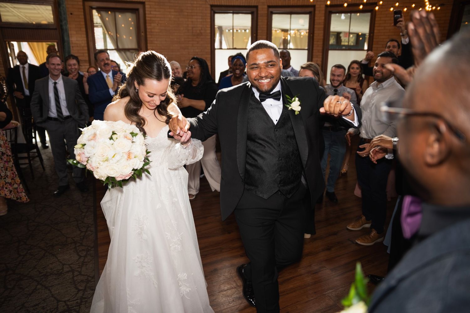 Wedding reception dance floor filled with joyful celebration and dancing.