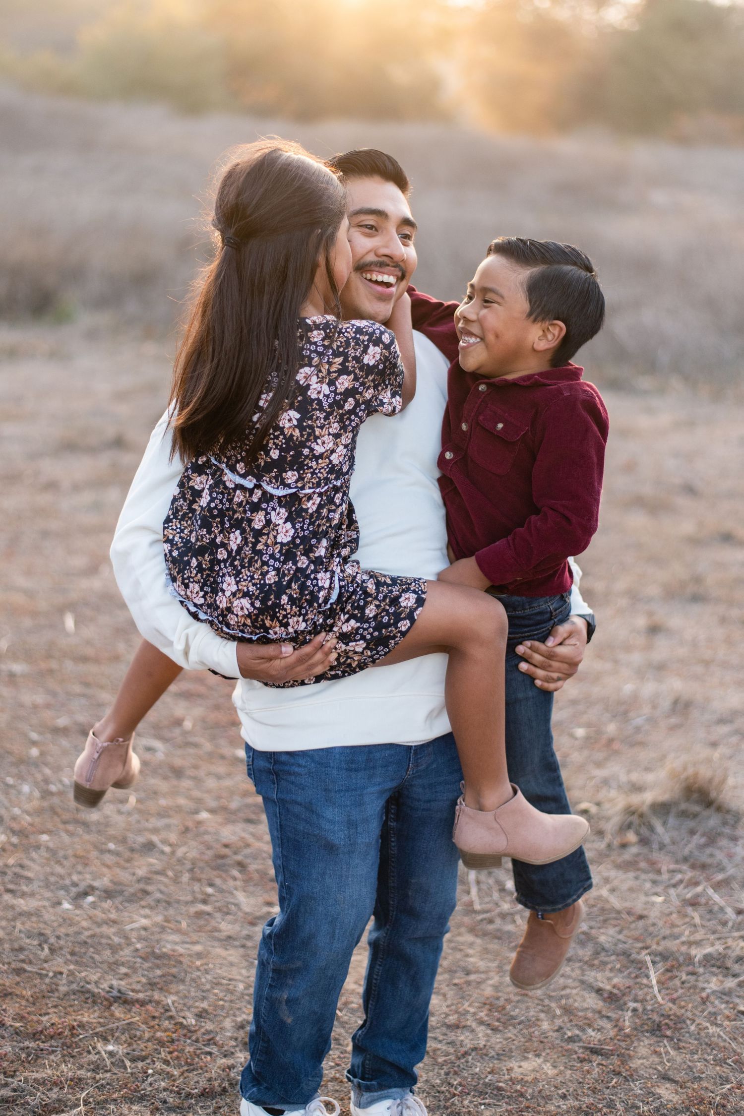 Sweet candid moments between parent and child playing outdoors at sunset.
