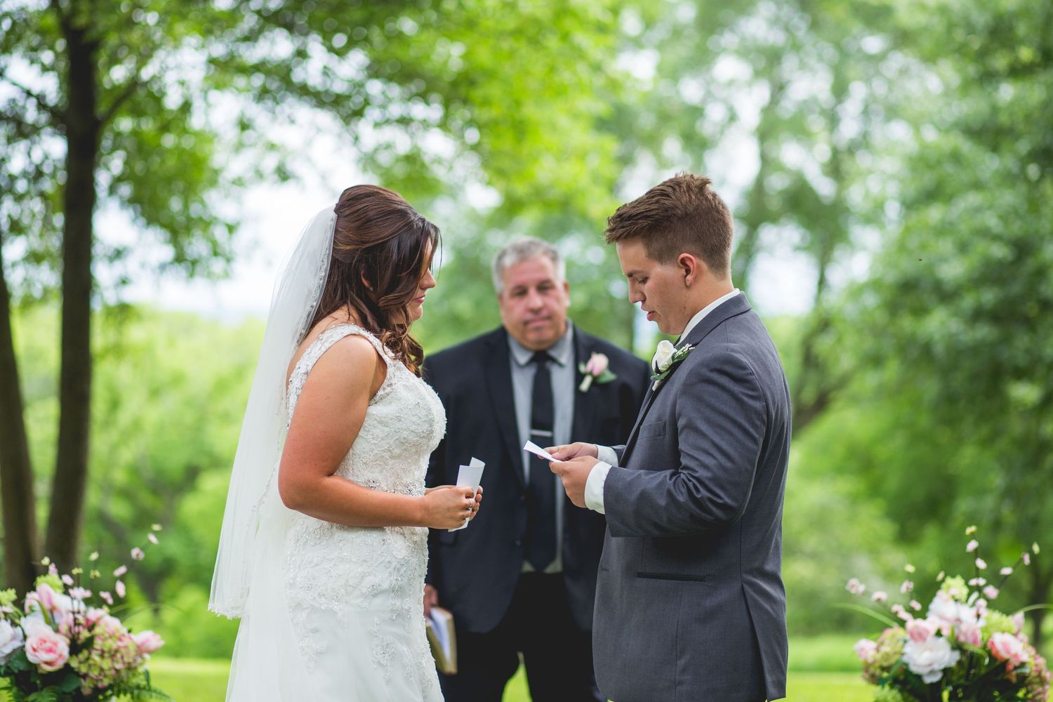 Groom reads his vows to his bride during their wedding ceremony.