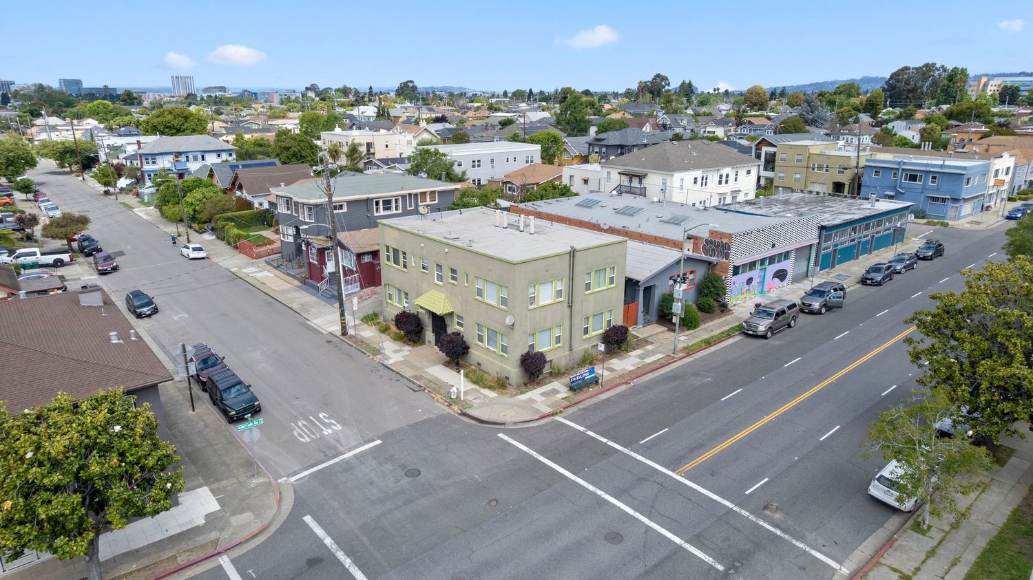 Aerial street view of urban mixed-use neighborhood with commercial and residential buildings.