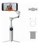 DJI OM 6 foldable smartphone gimbal stabilizer in white with accessories including cable and pouch.