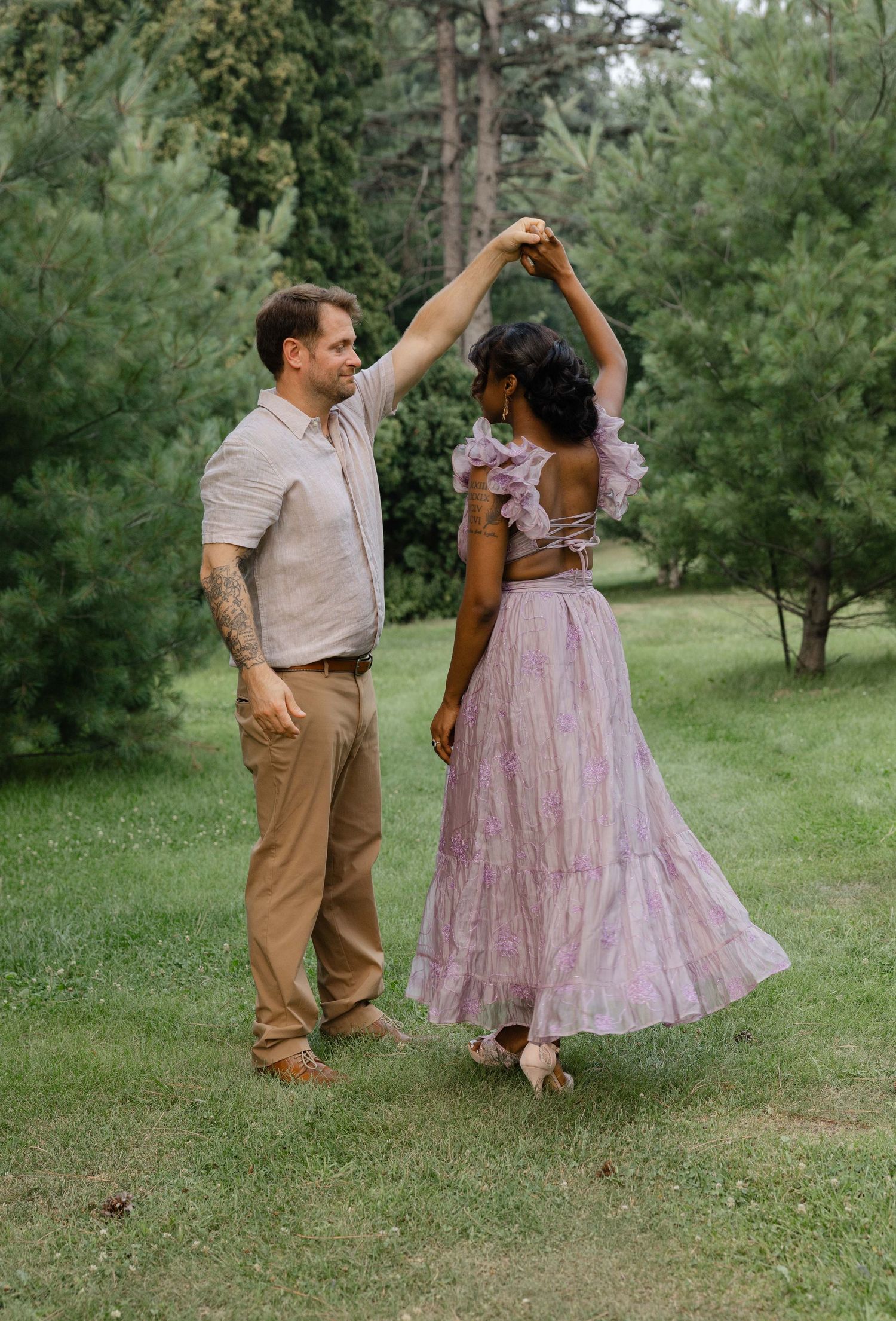 engagement session of a couple, dancing in a arnerson park in Edina, MN