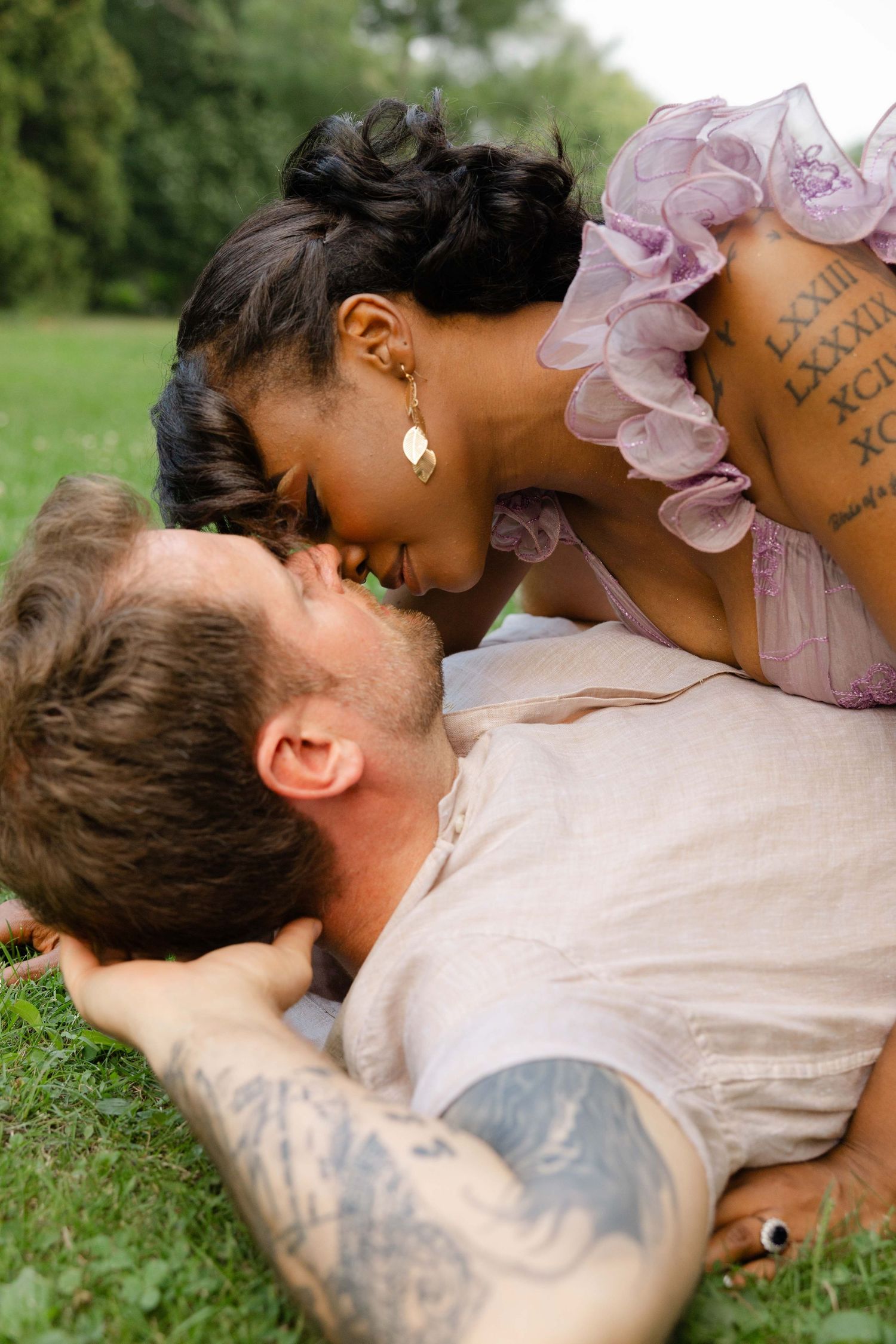 engagement session of a couple, kissing passionate in a arnerson park in Edina, MN