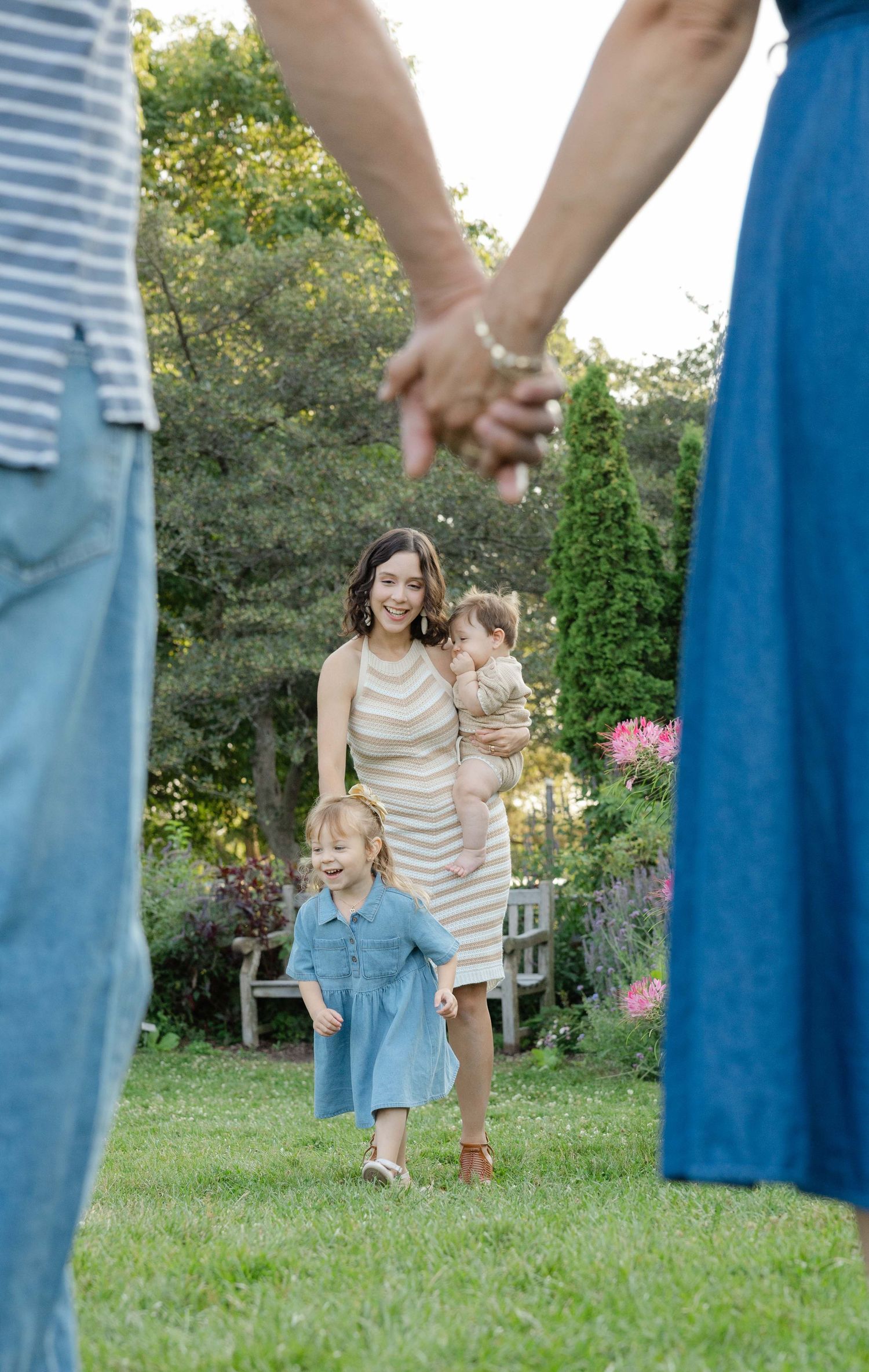 extended family artistic photo showing grandparents hands and kids and grandkids