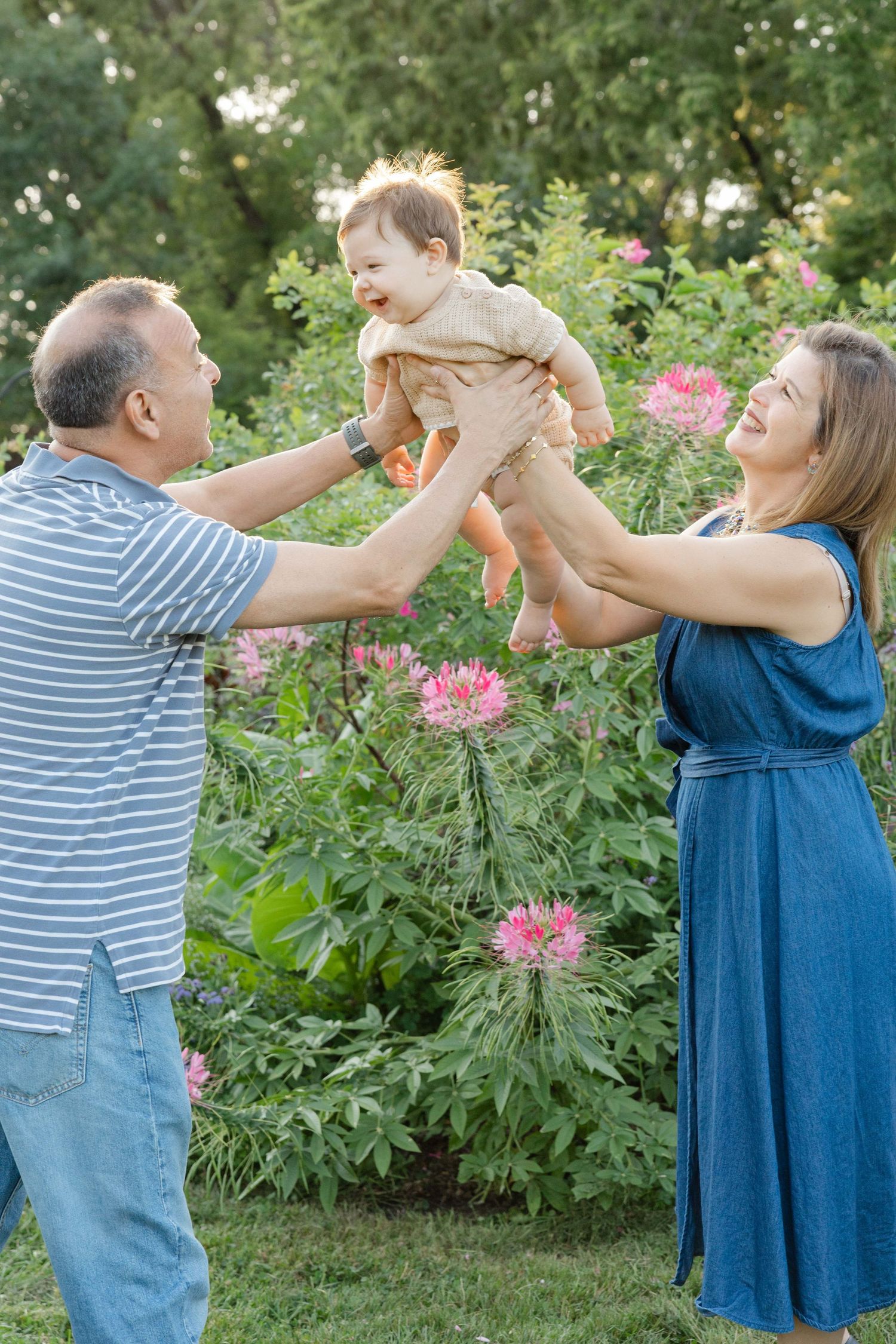 grandparents holding their grandchils and smiling during family session in Lakeville